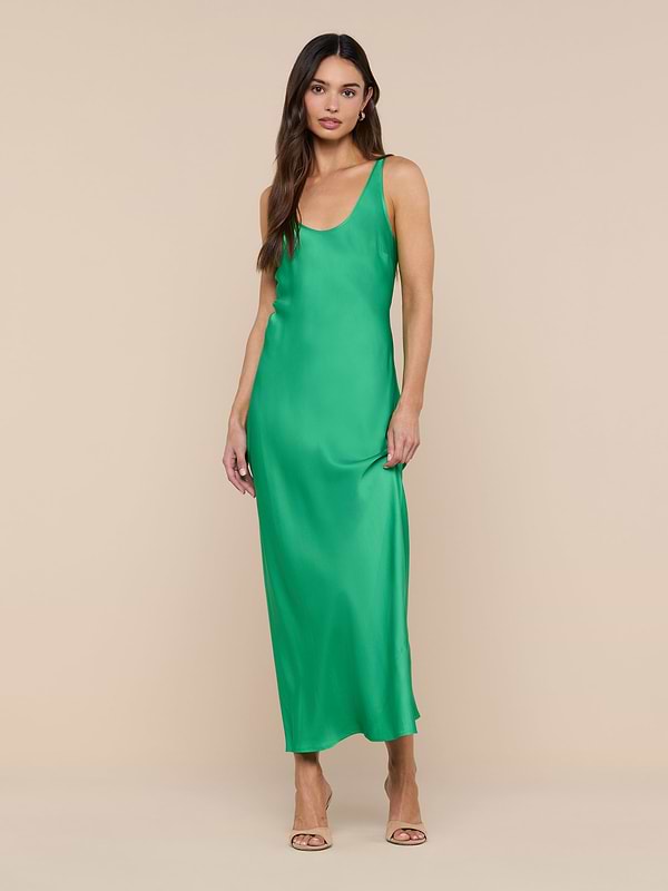 A woman stands against a white background wearing the Akiya Satin Maxi Dress in a sleeveless, island green bias-cut silhouette paired with open-toe heels.