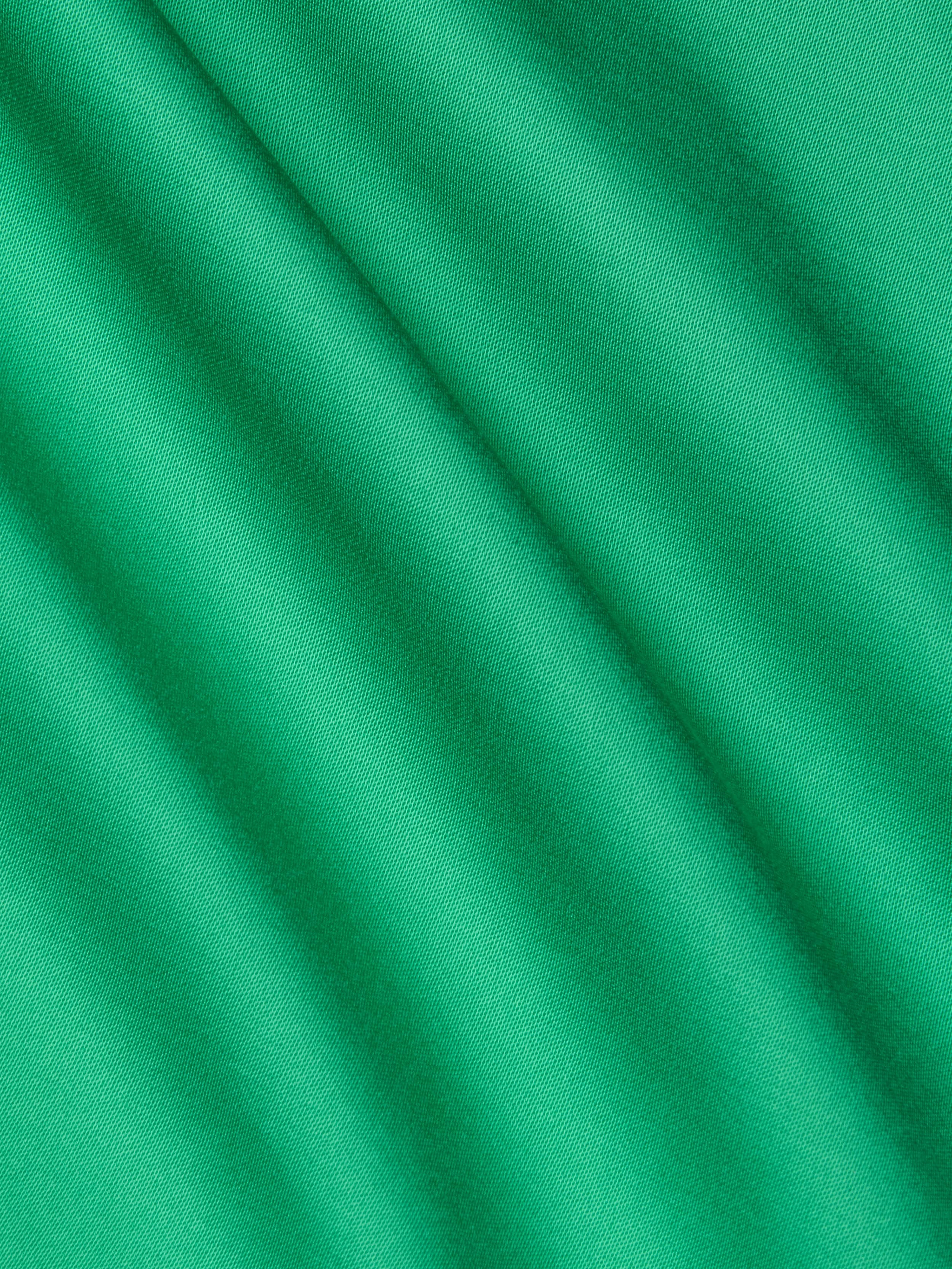 Close-up of smooth island green Akiya Satin Maxi Dress fabric with soft diagonal folds and gentle shadows, creating a subtle striped texture across the surface.
