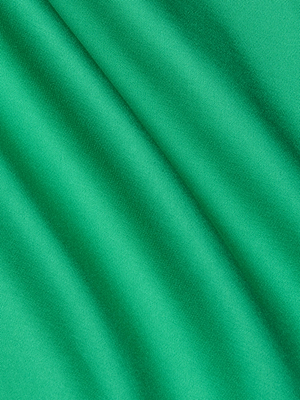 Close-up of the Akiya Satin Maxi Dress in island green, showcasing its smooth bias-cut satin fabric with diagonal folds and soft shadows that create an elegant play of light and dark across the surface.
