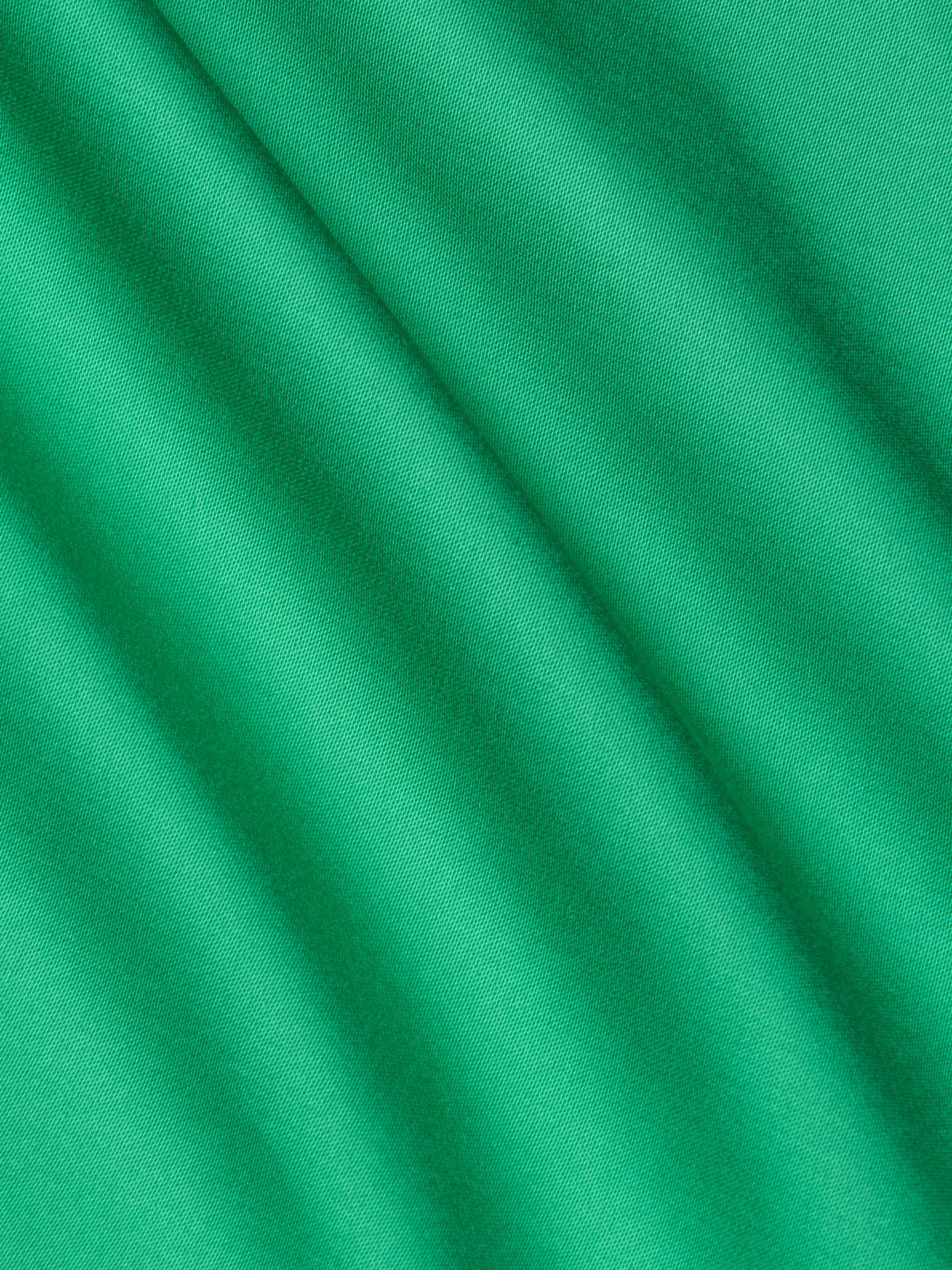 Close-up of smooth island green Akiya Satin Maxi Dress fabric with soft diagonal folds and gentle shadows, creating a subtle striped texture across the surface.