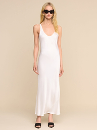 A woman wearing the Akiya Satin Maxi Dress, paired with black sandals and dark sunglasses, stands against a plain white background.