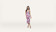 A woman wearing a sleeveless, floral-print dress and heels stands against a plain white background.