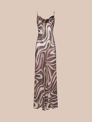 The Christine Silk Dress is a sleeveless, ankle-length bias-cut dress with thin spaghetti straps and a brown swirl print in cream and beige abstract patterns on a beige background.