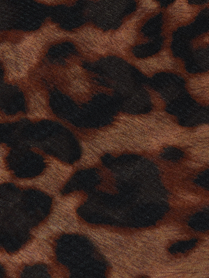 Close-up of the Christine Silk Dress by L'AGENCE, featuring a bold leopard print with irregular black spots on brown and tan silk—ideal for standout evening wear.