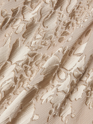 Close-up of the Christine Burnout Satin Gown’s beige fabric, showcasing a raised floral pattern with a soft sheen and diagonal folds that evoke an elegant, bias-cut silhouette.