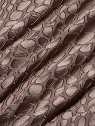 Brown, shiny fabric with an irregular, raised pebble-like pattern and diagonal folds, creating a textured appearance reminiscent of the Christine Burnout Satin Gown.