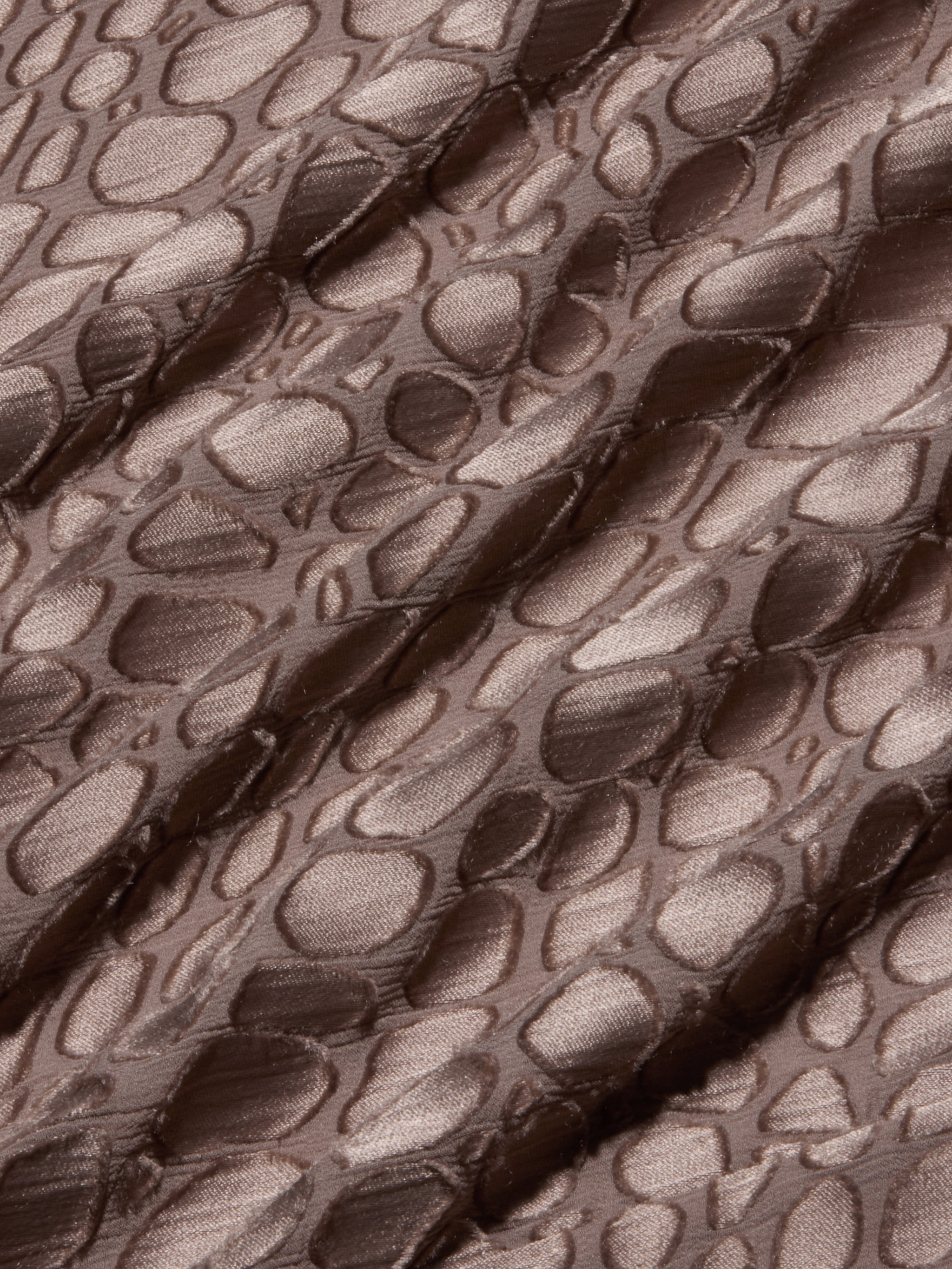 Brown, shiny fabric with an irregular, raised pebble-like pattern and diagonal folds, creating a textured appearance reminiscent of the Christine Burnout Satin Gown.