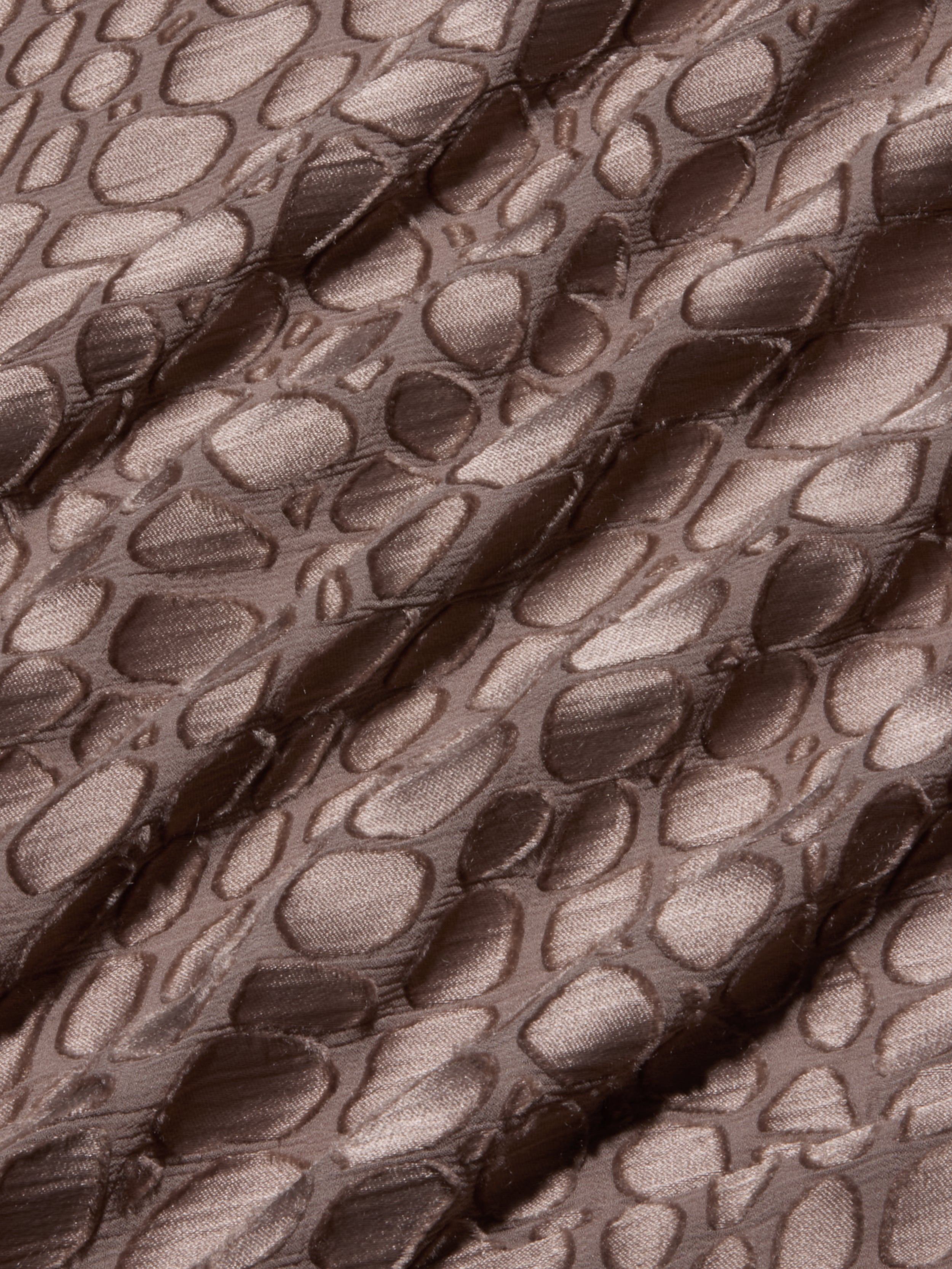 Brown, shiny fabric with an irregular, raised pebble-like pattern and diagonal folds, creating a textured appearance reminiscent of the Christine Burnout Satin Gown.
