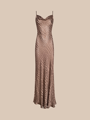 The Christine Burnout Satin Dress is a sleeveless, floor-length bias-cut dress with thin straps and a brown and beige cobra print on burnout satin, shown against a plain beige background.