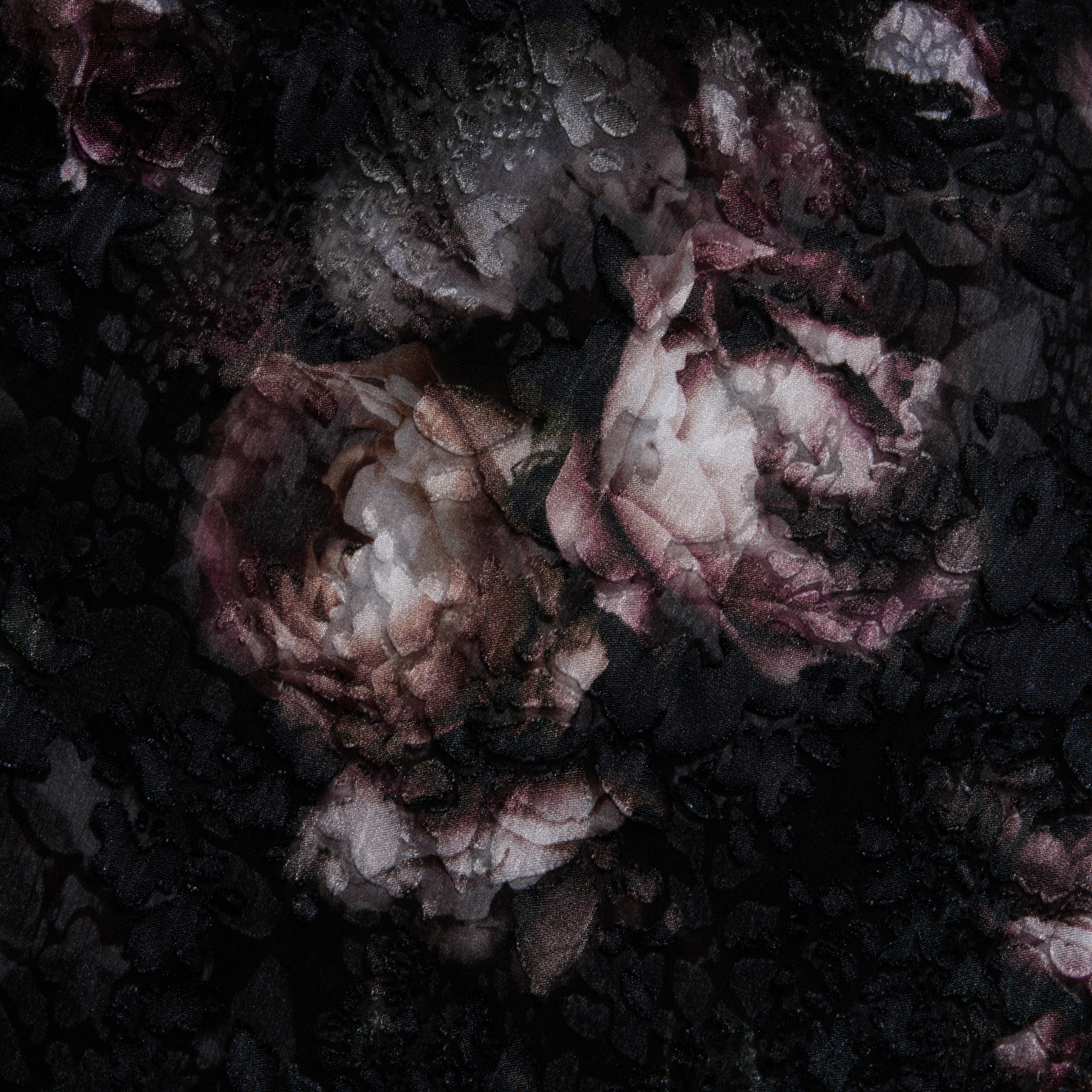 Pink and white peonies with green leaves are partially obscured by a layer of delicate black lace, creating a dark, moody, and textured floral scene reminiscent of the rose print on the Christine Dress’s sheer gown fabric.