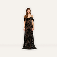 The Kenna Velvet Gown is a floor-length black burnout velvet gown with cold-shoulder sleeves and a sheer overlay featuring a black floral pattern.