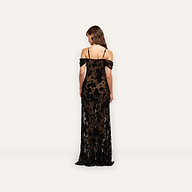 Back view of the Kenna Velvet Gown, a floor-length, off-the-shoulder burnout velvet dress with thin straps and a black floral pattern over a dark base.