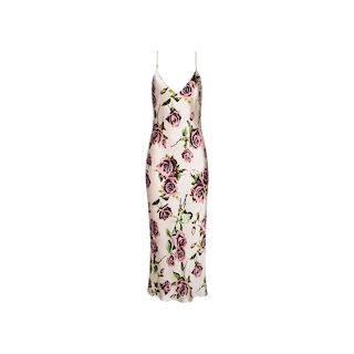 The Seridie Silk Slip Dress is a sleeveless, midi-length dress featuring thin spaghetti straps and a pink and purple rose print floral pattern on a white background, beautifully shaped with a flattering bias cut.