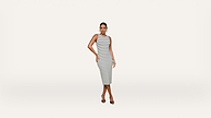 Woman wearing a sleeveless, knee-length, black and white striped dress and black heels stands against a plain white background, posing with one hand on her hip.