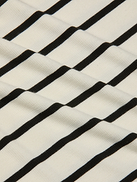 Close-up of the Nura Racerback Midi Dress fabric, featuring black horizontal stripes on a white background that create a wavy, textured pattern.