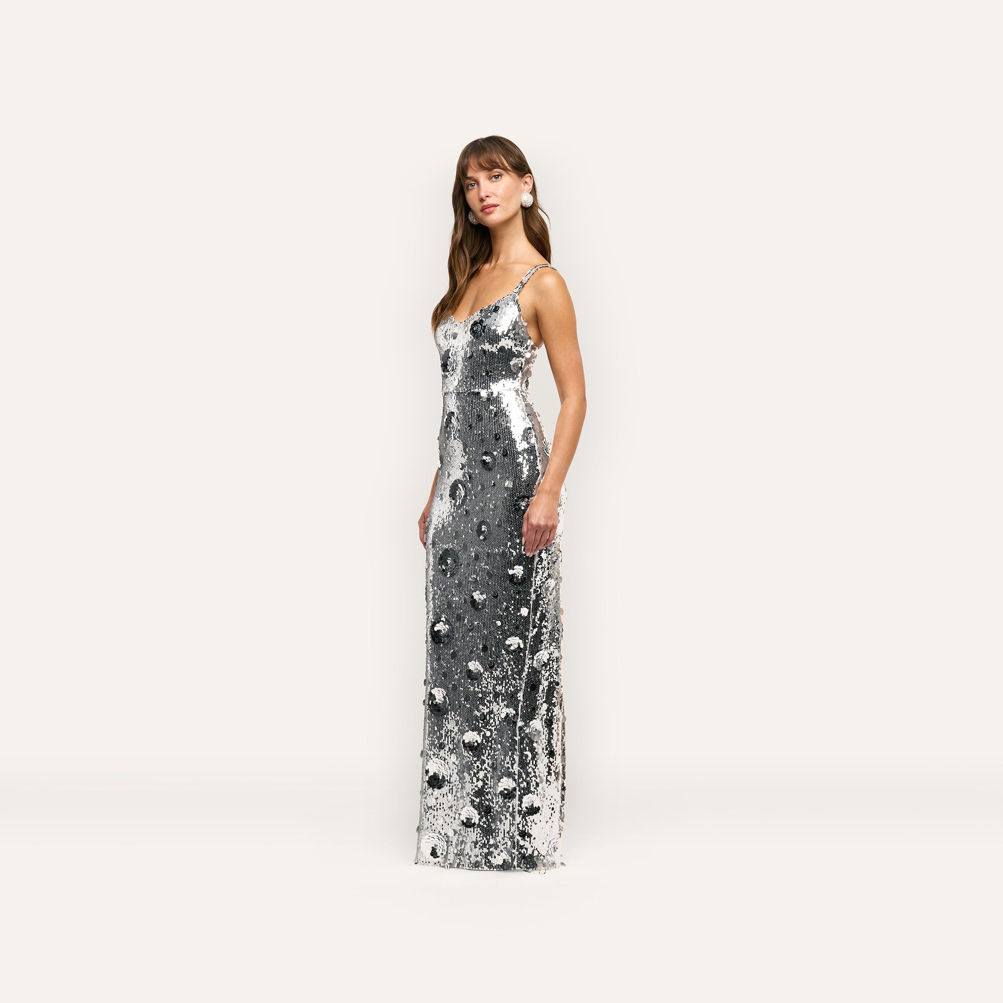 A floor-length, spaghetti-strap silver sequin Karma Sequin Maxi Dress.