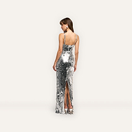 Karma Sequin Maxi Dress in silver featuring a full-length silhouette, spaghetti straps, a back slit, and silver heels for an elegant look.