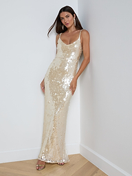 A woman wearing the Karma Sequin Maxi Dress and heels stands against a plain white background, embodying the elegance of NYFW 2026.