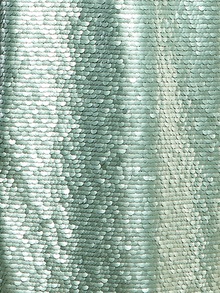 Close-up of the Karma Sequin Maxi Dress, featuring a shimmering, light green sequin fabric with a textured, reflective surface. Matte teal sequins are arranged in a scale-like pattern that catches and reflects light, adding depth and subtle contrast to the design.