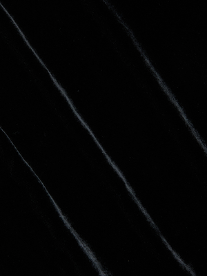 Close-up of the Saint Velvet Gown by L'AGENCE, showcasing its black velvet fabric with subtle diagonal lines and a soft, slightly shiny texture.