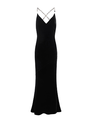 The Saint Velvet Gown by L'AGENCE is a long, sleeveless black velvet dress featuring a fitted silhouette, flared hem, and thin crystal straps that crisscross at the neckline.