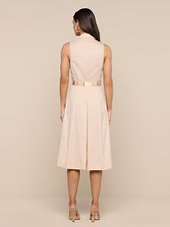 A woman stands facing away, wearing the Kylo Poplin Shirt Dress with nude heels, against a plain white background.