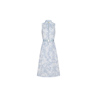 Kylo Shirt Dress: A sleeveless, collared button-down shirt dress showcasing a blue and white floral pattern inspired by a blue lace print, finished with a coordinating waist belt—ideal for seamless desk-to-drinks style. Shown on a plain white background.