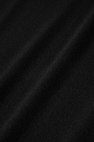 Close-up of a black microfiber modal jersey fabric with a soft texture and diagonal folds, showcasing fine weave details and subtle shadows across the surface—making it an ideal choice for the Voletta Turtleneck Knit Dress and a must-have essential for fall to winter.