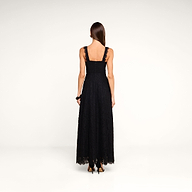 A woman in the Sutton Lace Maxi Dress, featuring black lace and a supportive fit, paired with black heels, stands facing away from the camera against a plain white background.