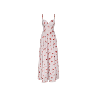 The Sutton Maxi Dress is a long, sleeveless white dress with thin beaded straps and a sweetheart neckline, featuring an all-over red lipstick-kiss print pattern—perfect for a date night.