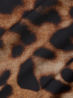 Close-up of the Sutton Beaded Strap Maxi Dress by L'AGENCE, highlighting its leopard print fabric with brown and black irregular spots on a light background.