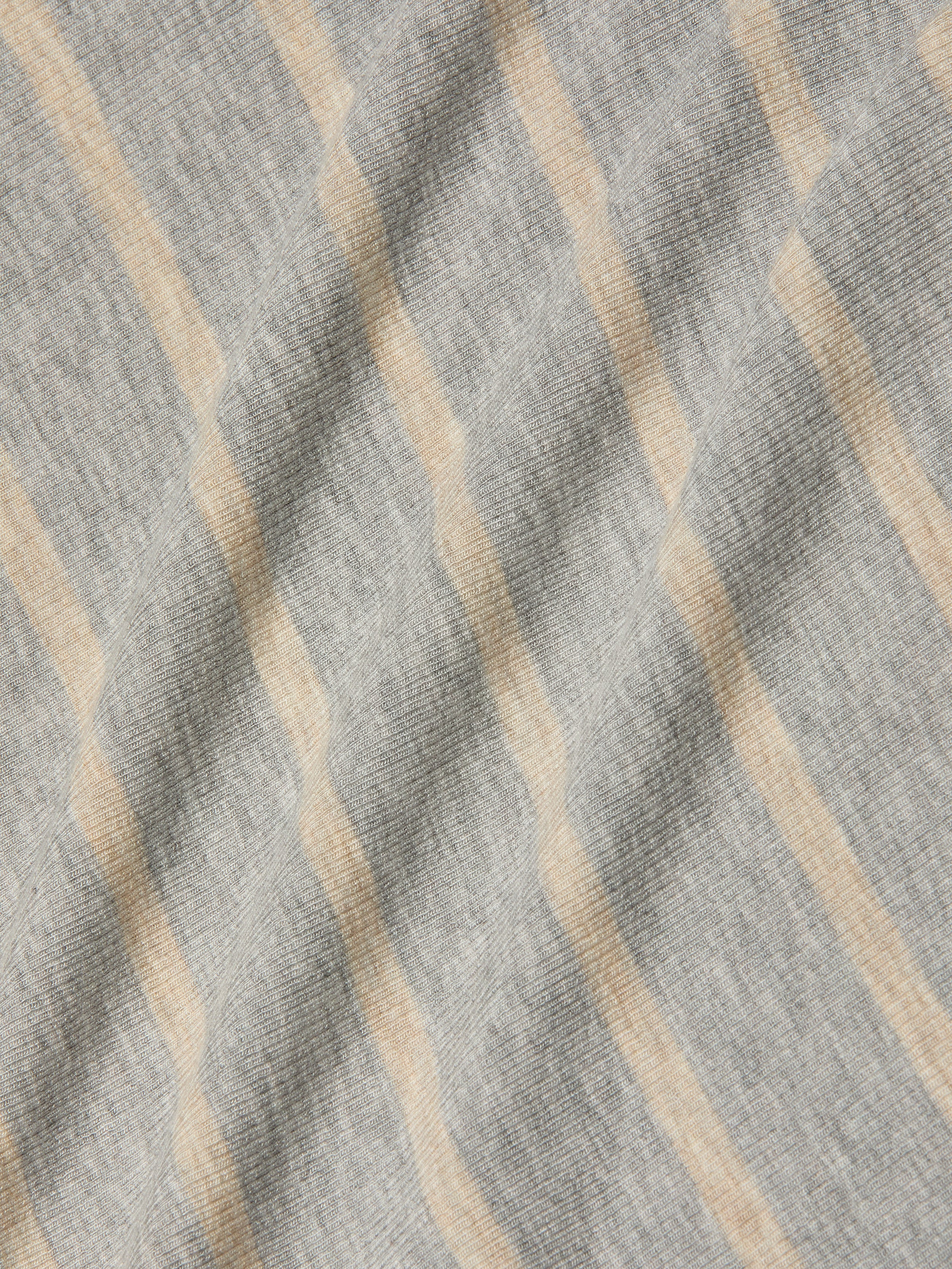 A close-up of the Ellis Tank Dress in gray stretch rib fabric with soft beige horizontal stripes, highlighting its slightly wrinkled, textured surface—perfect for a comfy, casual style.