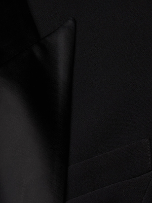 Close-up of the Esti Mini Dress in black, featuring the lapel, collar, and chest pocket. The smooth fabric and sharp lines offer a modern twist on feminine power dressing.
