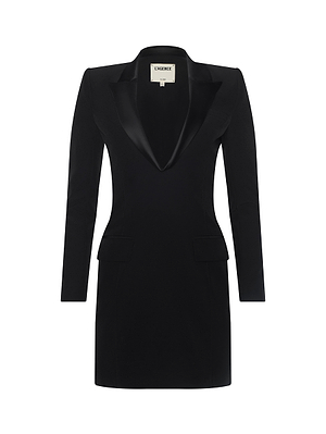 The Esti Mini Dress is a black tuxedo-style mini dress with long sleeves, satin lapels, a deep V-neckline, structured shoulders, flap pockets, and a slightly fitted silhouette, shown against a white background.