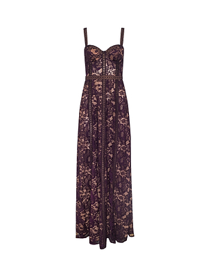 The Laynie Lace Maxi Dress is a sleeveless design with thin straps, showcasing dark purple floral Chantilly lace over a nude base. Its fitted bodice flows into a flared, full-length skirt for an elegant silhouette.