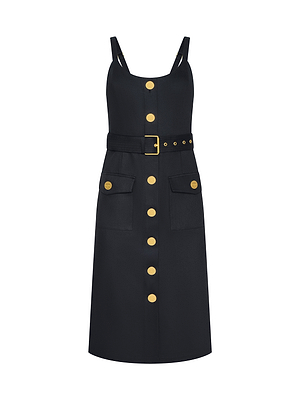 The Ida Dress is a sleeveless black dress with gold buttons, wide straps, stretch cotton fabric, tailored fit, matching belt with gold buckle, and two front flap pockets accented with gold buttons.