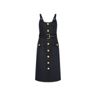 The Ida Dress is a sleeveless black stretch cotton dress featuring shoulder straps, gold buttons down the front, two large front pockets adorned with gold buttons, and a matching belt with a gold buckle, displayed on a plain white background.