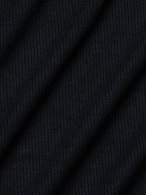 Close-up of black ribbed fabric with diagonal ridges, highlighting the textured surface of L'AGENCE's Astra Midi Dress, crafted from stretch modal for a figure-flattering silhouette.