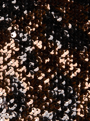Close-up of reversible black and bronze sequins on the L'AGENCE Noella Sequin Dress, reflecting light for a shimmering, textured surface with dramatic dark and metallic tones.