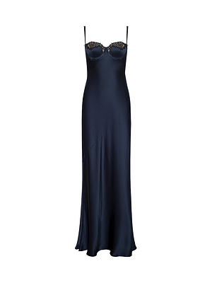 The Shayla Silk Lace Gown is a long navy blue slip dress with thin spaghetti straps and lace detailing on the bust, shown on a white background.
