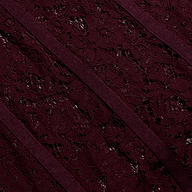 Close-up of the Jennifer Lace Midi Dress featuring deep burgundy floral lace accented by diagonal ribbon trim.