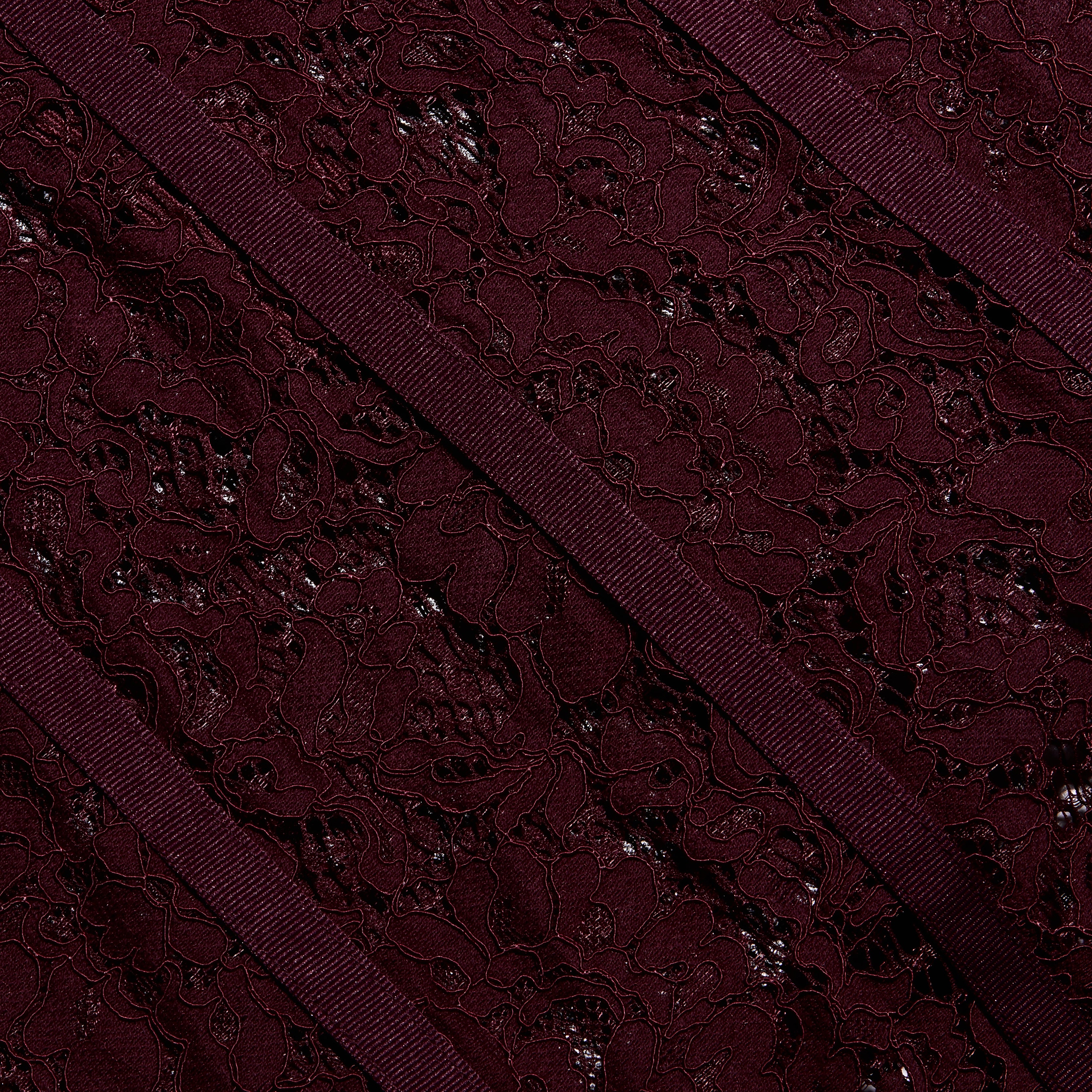 Close-up of the Jennifer Lace Midi Dress featuring deep burgundy floral lace accented by diagonal ribbon trim.