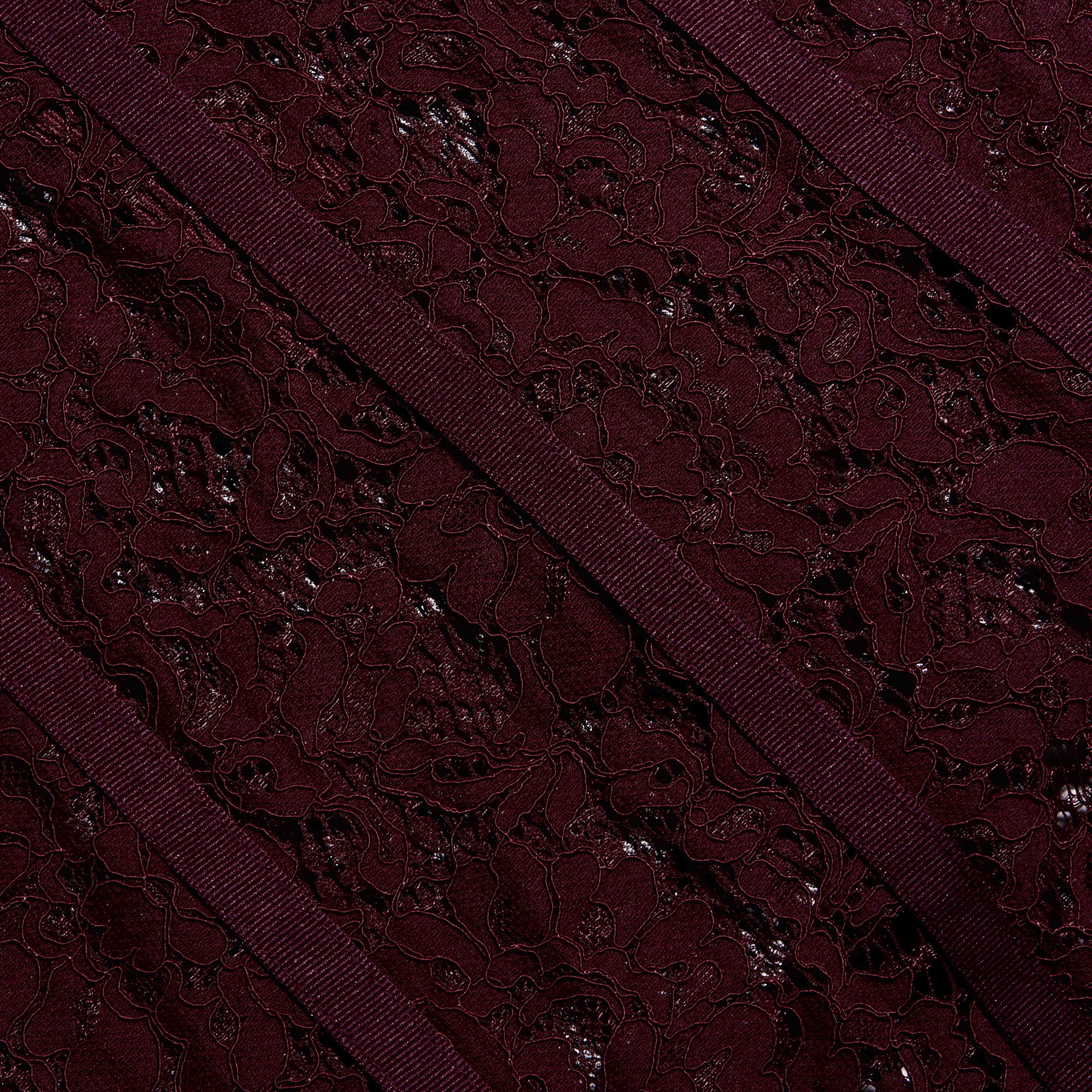 Close-up of the Jennifer Lace Midi Dress featuring deep burgundy floral lace accented by diagonal ribbon trim.