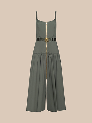 The Rima Dress is a sleeveless olive green dress with a square neckline, front zipper, fitted bodice, belted waist, and flared pleated skirt. It features adjustable straps for a customizable fit and is shown on a beige background.