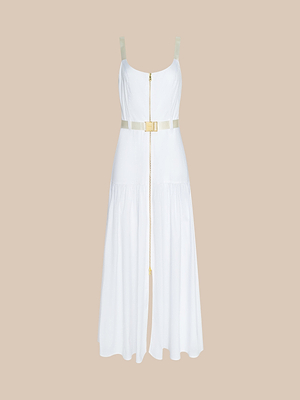 The Rima Dress is a sleeveless white maxi in stretch poplin, featuring a front zipper, fitted bodice, belted waist, and long flowy skirt, shown on a beige background.