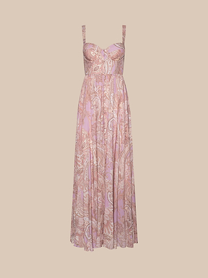 The Rosette Maxi Dress is a sleeveless, floor-length dress with wide straps and a fitted bodice, showcasing a mauve paisley pattern on soft, flowing fabric, displayed against a plain beige background.