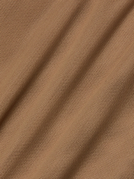 Close-up of light brown stretch mesh fabric with diagonal folds and visible small holes, creating a textured and patterned surface often used as bodysuit lining for garments like the Sorella Mesh Midi Dress.