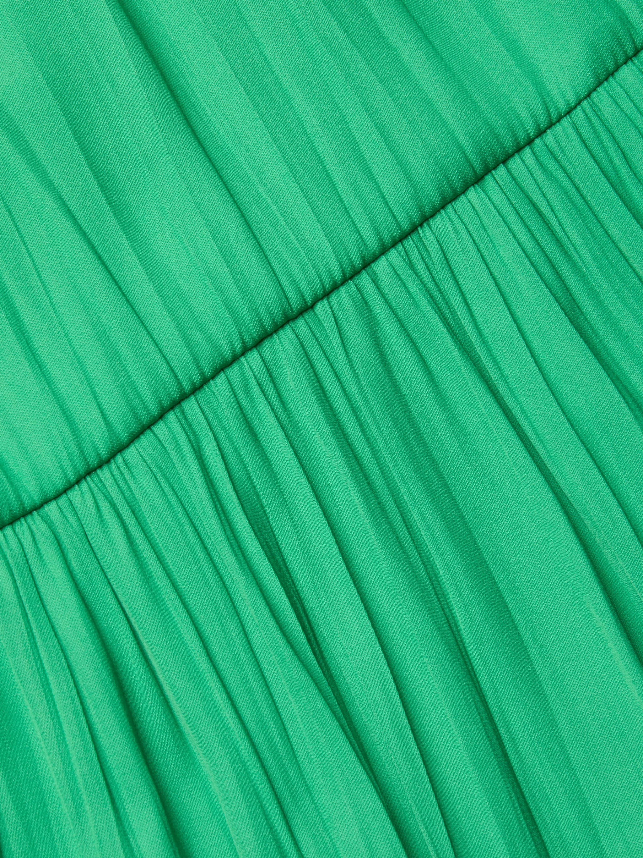 Close-up of the gathered green crinkle-effect satin fabric on the Lua Tiered Maxi Dress, featuring a horizontal seam that highlights its pleats and textured look.