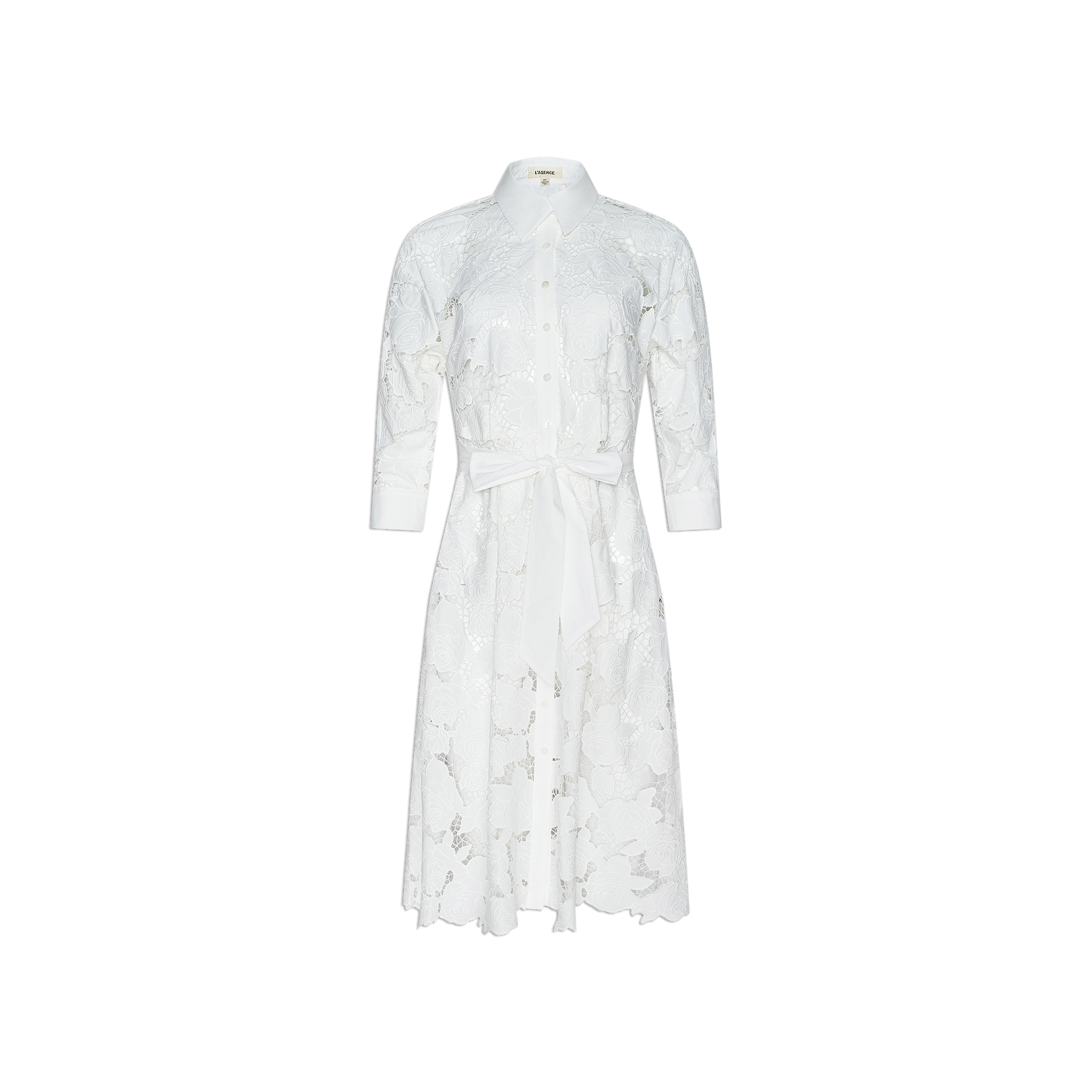 May Eyelet Shirt Dress—crafted from white cotton with eyelet detailing, this midi dress features long sleeves, a button-down front, collar, and a matching fabric waist tie. Shown against a plain white background.