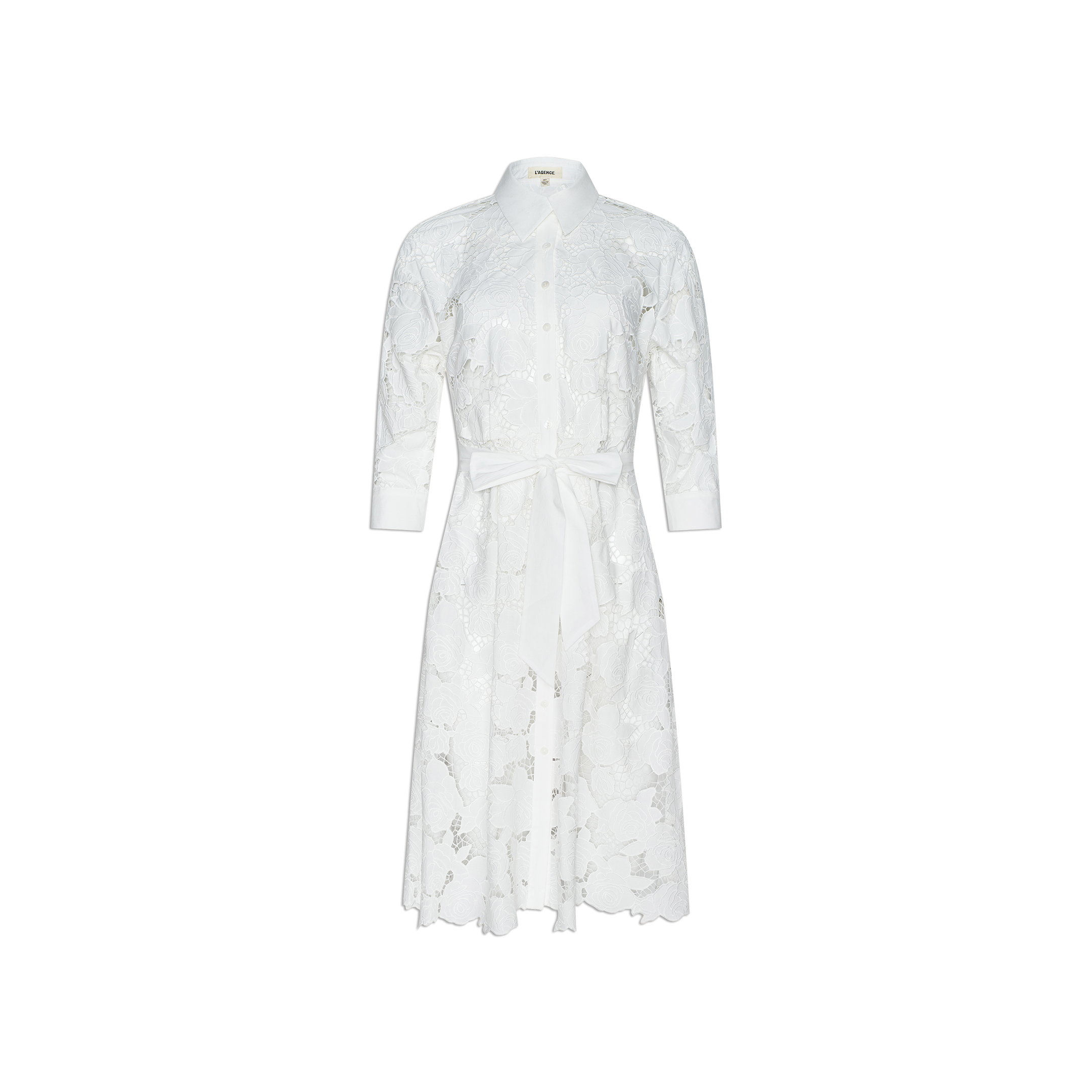 May Eyelet Shirt Dress—crafted from white cotton with eyelet detailing, this midi dress features long sleeves, a button-down front, collar, and a matching fabric waist tie. Shown against a plain white background.